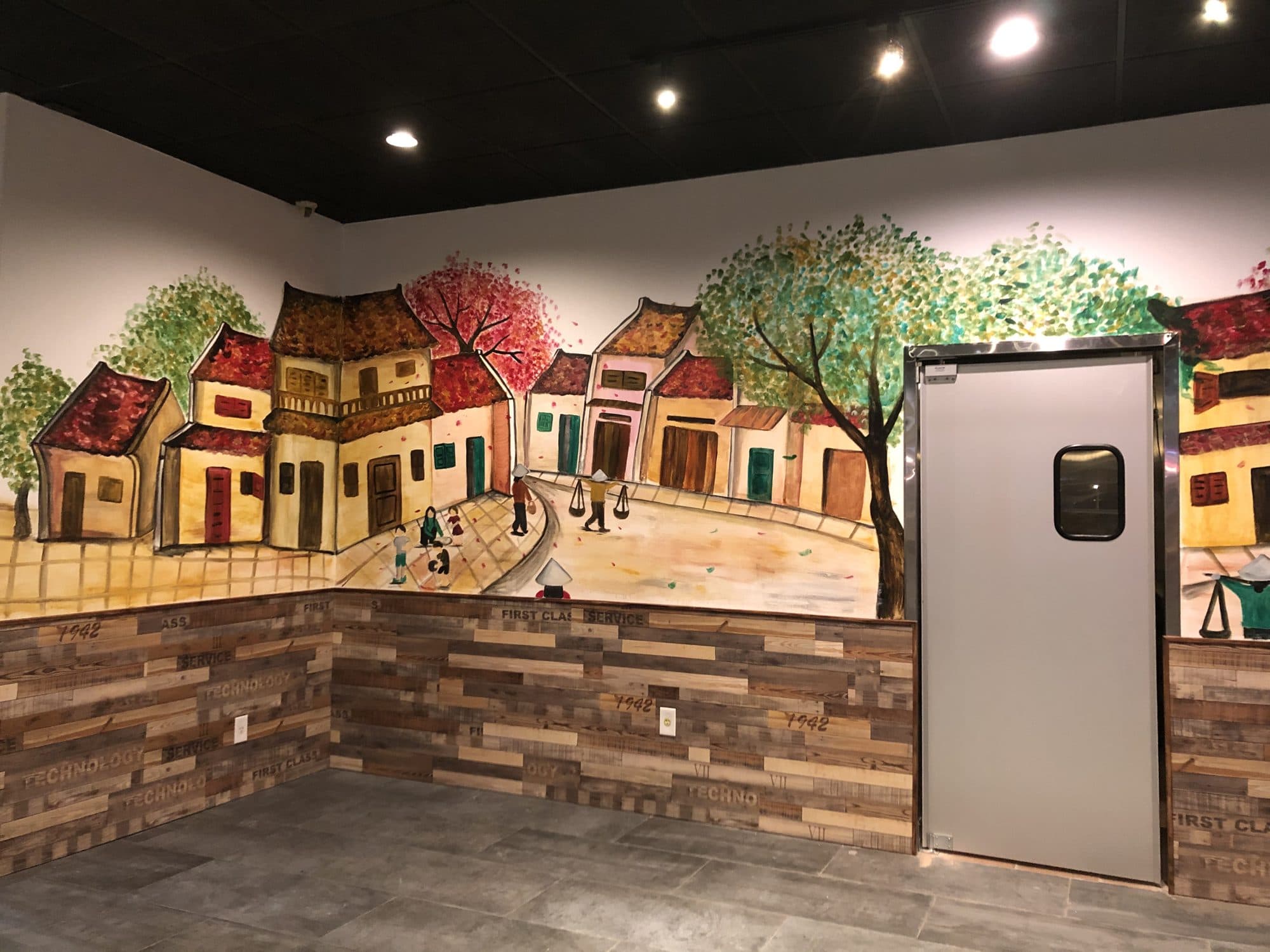 Mural of old Vietnamese town houses wrapping the Hà Nội Corner dining room in Garden Grove