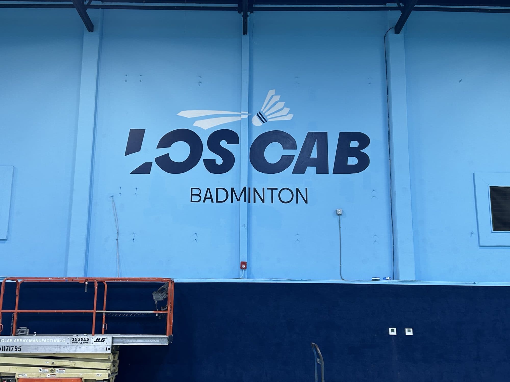 Finished LOS CAB Badminton brand wall in navy and blue